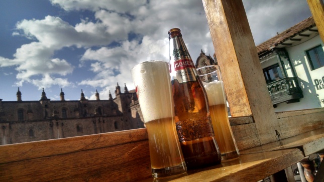 foamy beer with the cathedral in the background